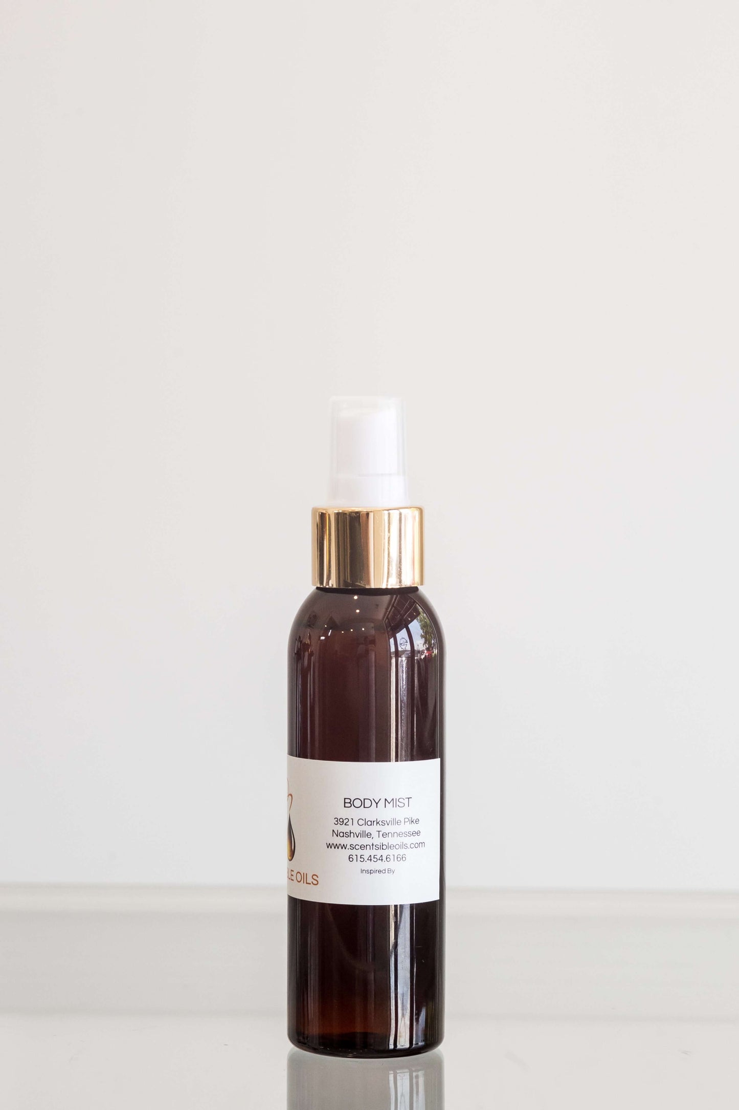 Men Body Mist bottle with elegant design and gold accents, perfect for a refreshing scent.